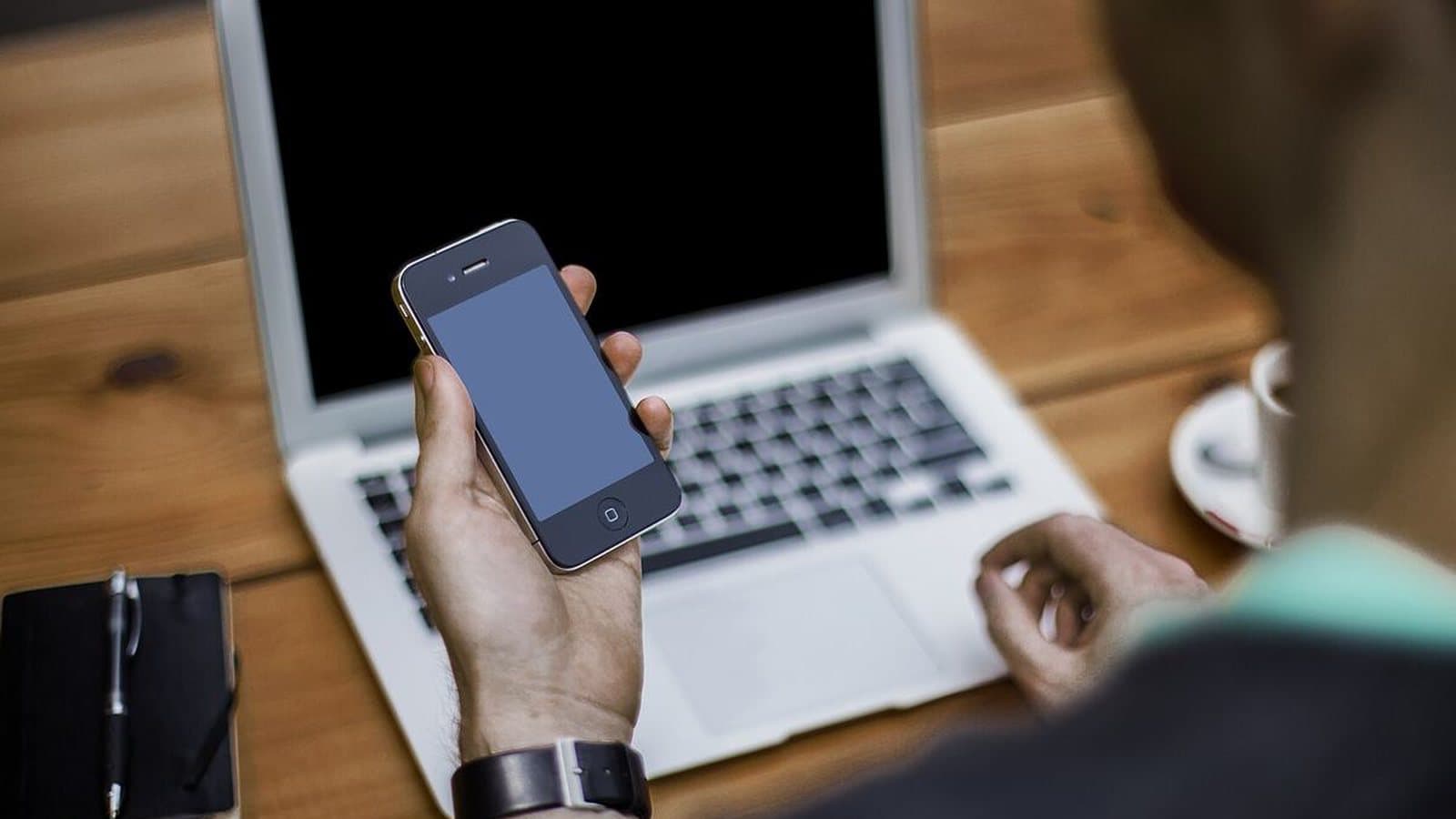Streaming video on a phone next to a laptop